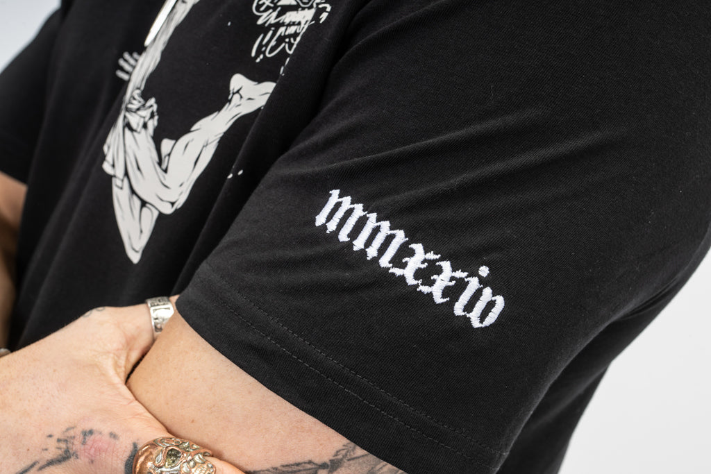 Roman Numeral detailing on a Black Born Otuta Fire T Shirt