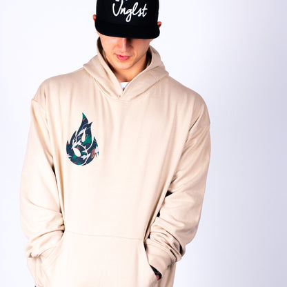 Person wearing a beige hoodie with a colorful logo and a black cap with 'Vingst' text on a white background