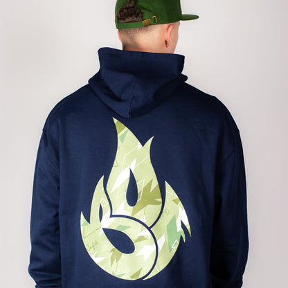 Person wearing a navy hoodie with a green Junglist flame design on the back against a plain background
