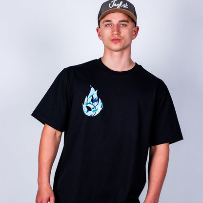 Person wearing a black t-shirt with a blue graphic design on a plain background