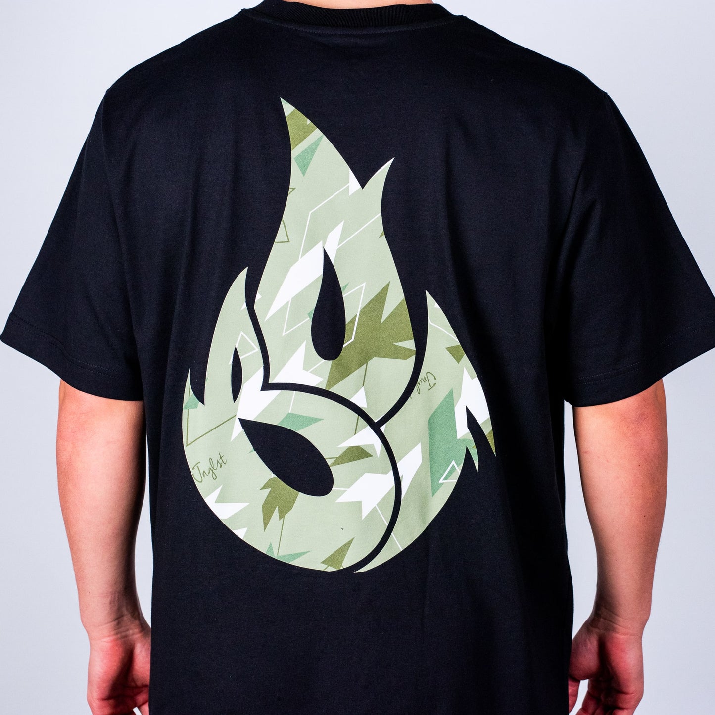 Black t-shirt with a green Camo design on the back against a plain background