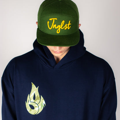 Person wearing a green cap with yellow text and a navy Born Outta Fire hoodie with a green logo on a plain background