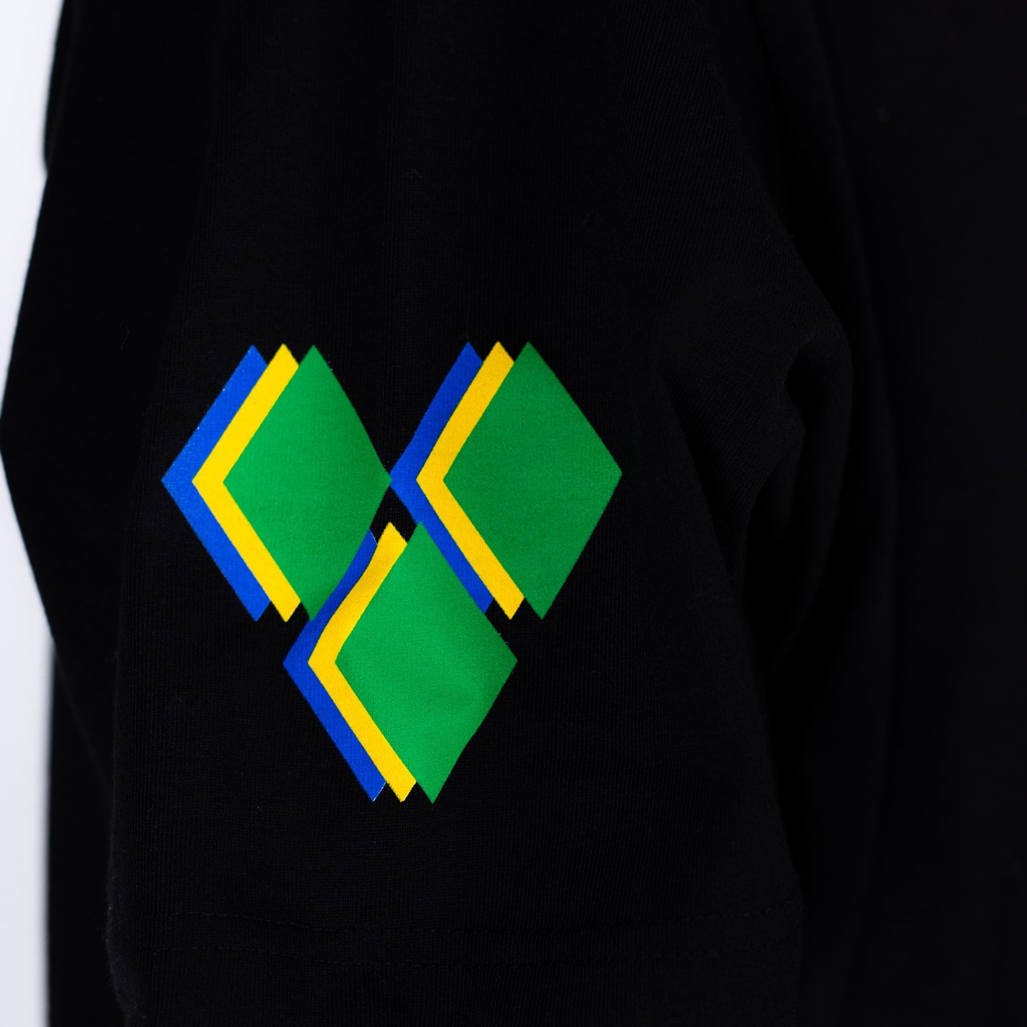 Black shirt with a green and blue geometric design on a white background