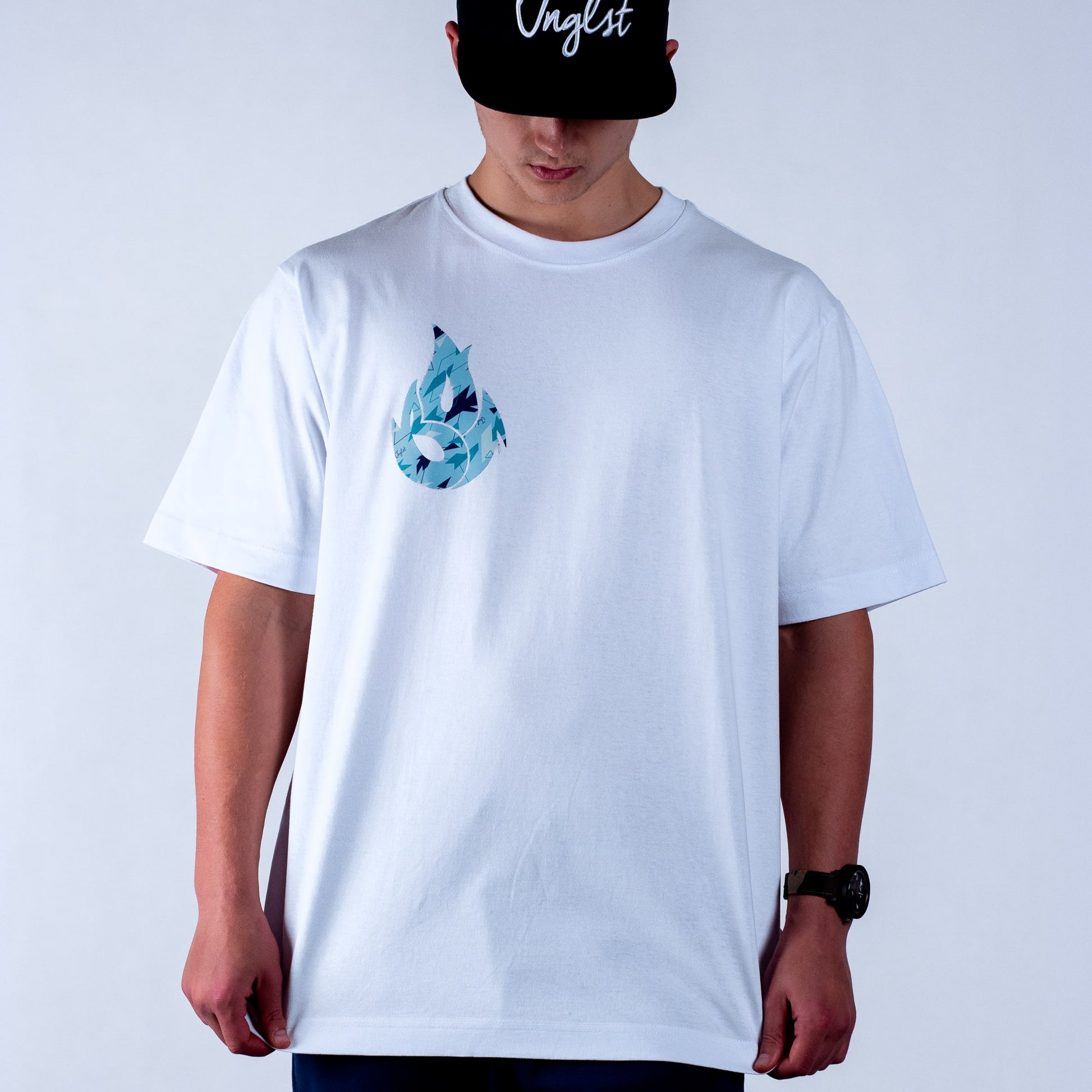 Person wearing a white t-shirt with a blue camo graphic design on a plain background