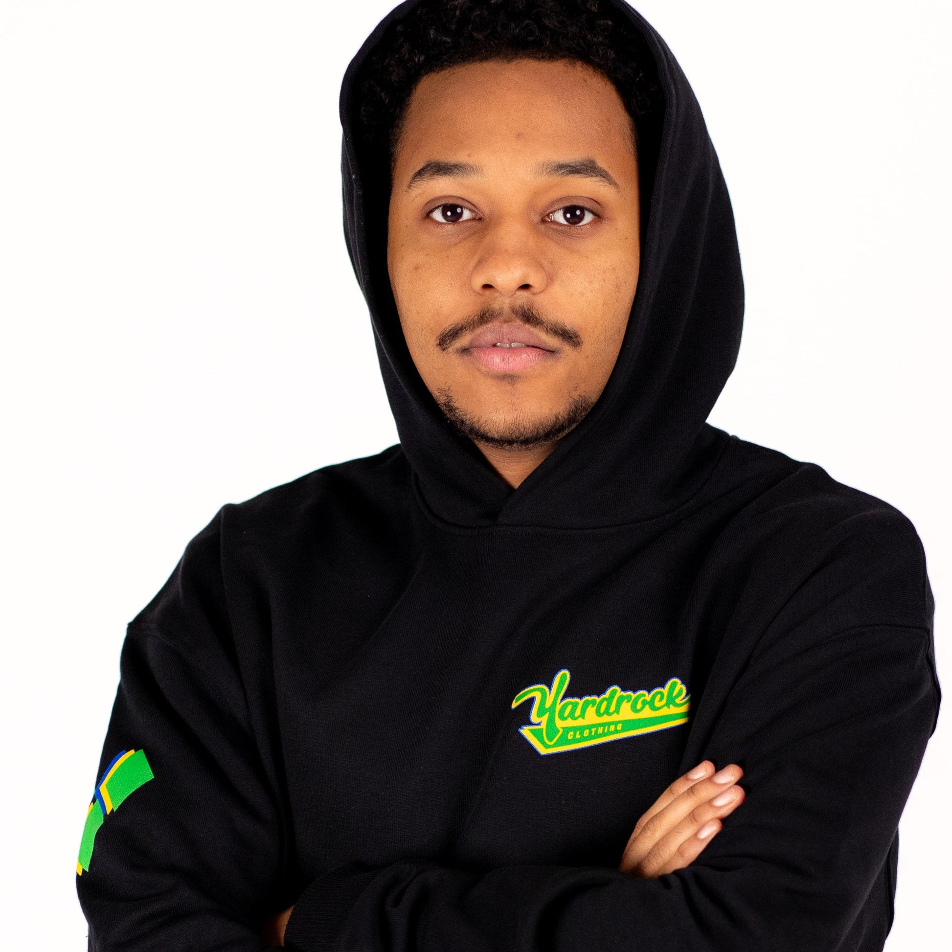 Person wearing a black yardrock diamond hoodie with a visible brand logo on a white background
